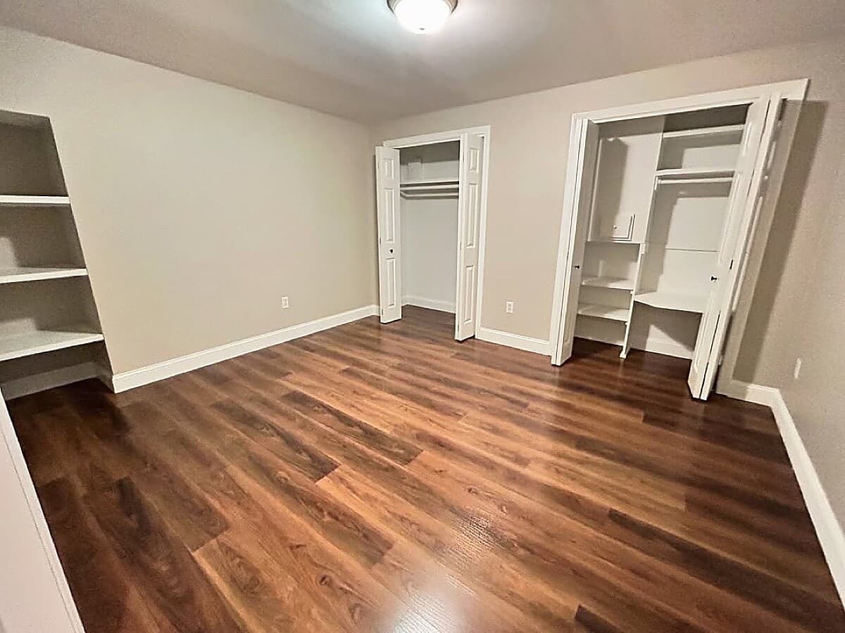 Finished basement bedroom with custom built-in closets