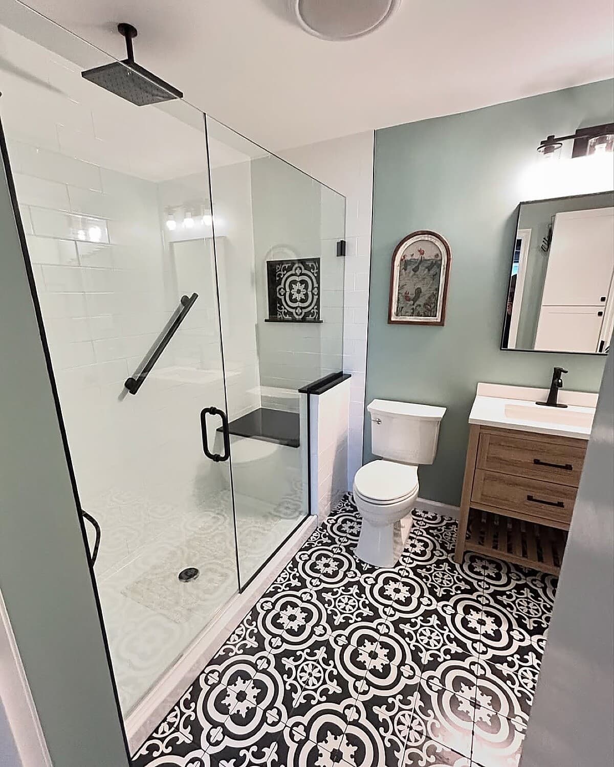 Bathroom with decorative patterned floor tile and glass walk-in shower
