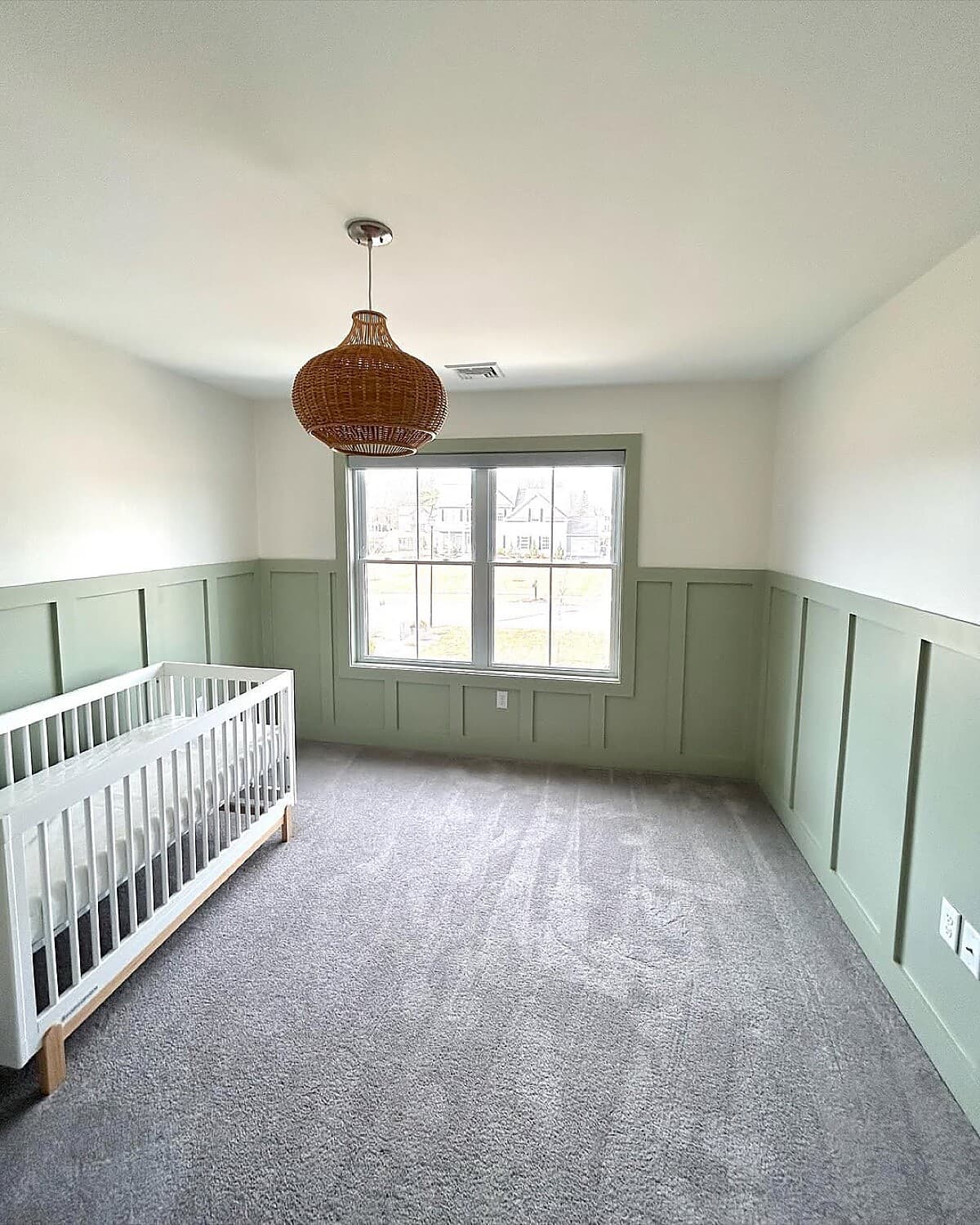 Nursery with sage green board-and-batten wainscoting