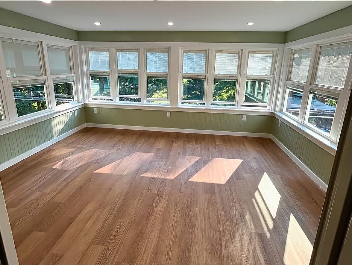 Sunroom with wrap-around windows and beadboard wainscoting detail