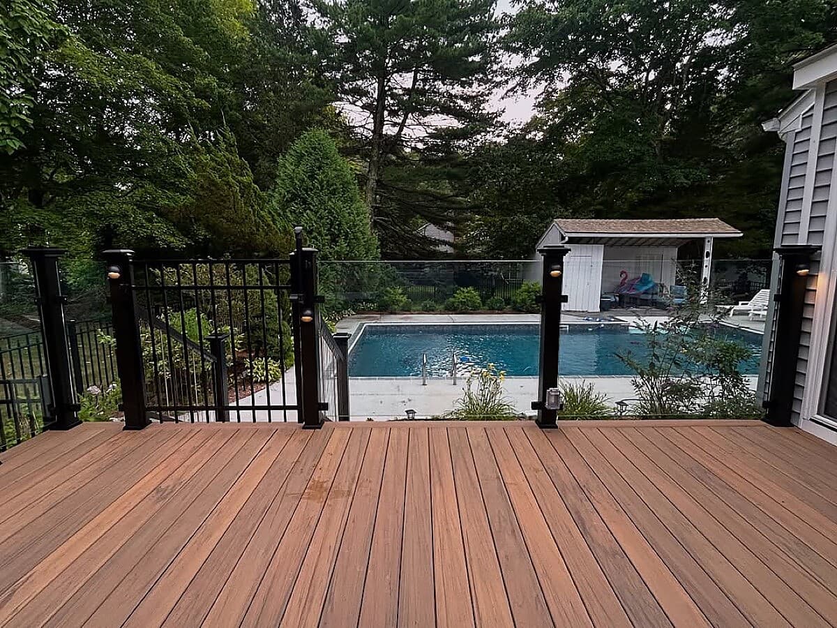 Deck stairs with composite treads, lattice skirting, and step lights
