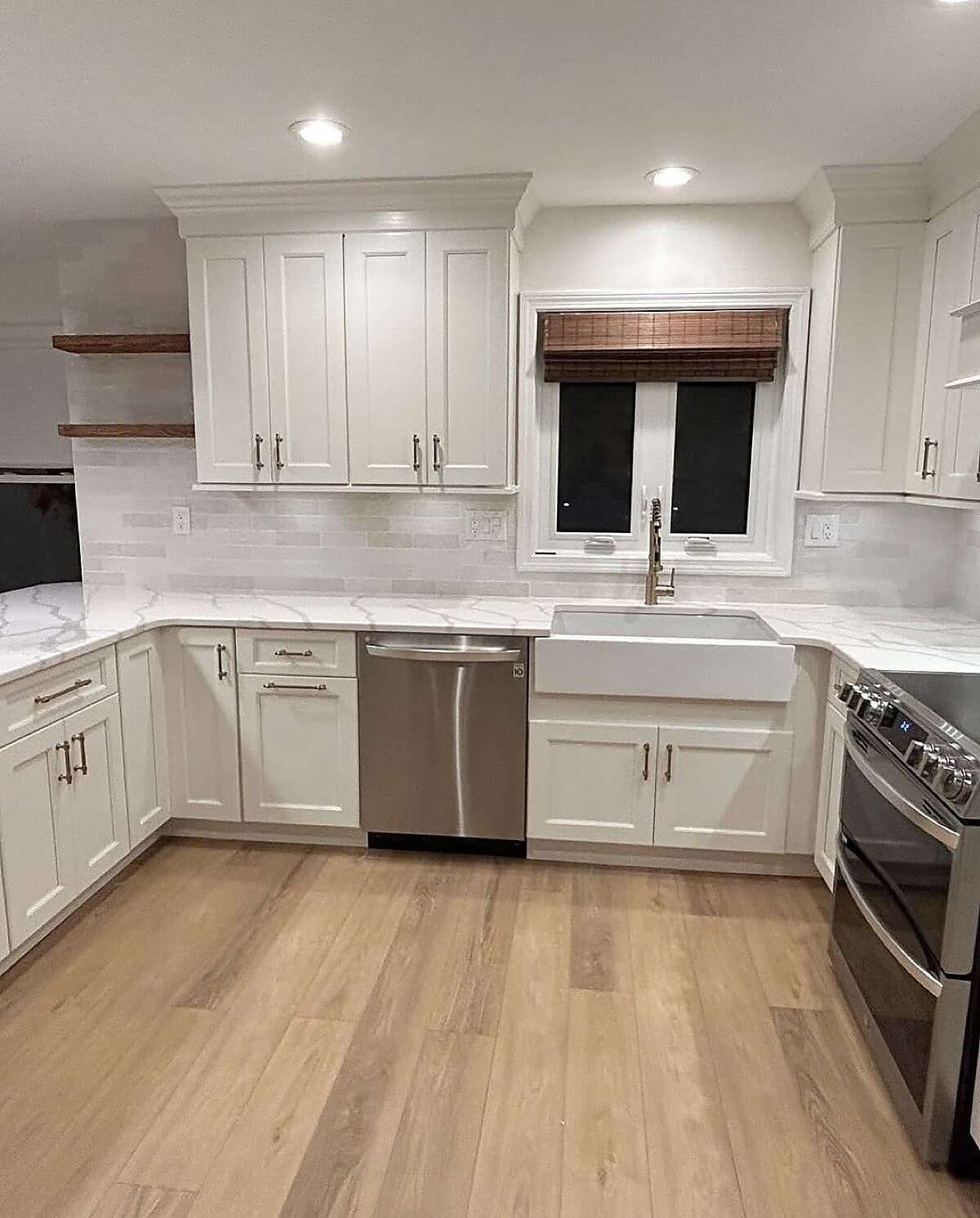 Kitchen remodel with quartz countertops, farmhouse sink, and floating shelves